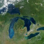 True-color Moderate Resolution Imaging Spectroradiometer (MODIS) image. The pale blue swirls in Lake Michigan are probably caused by a phytoplankton bloom or calcium carbonate (chalk) from the lake's limestone floor. Concrete-grey patches mark the locations of several cities throughout the Great Lakes region. Red dots indicate active fire locations. Sensor: Aqua/MODIS. Visualization Date: 2003-09-18