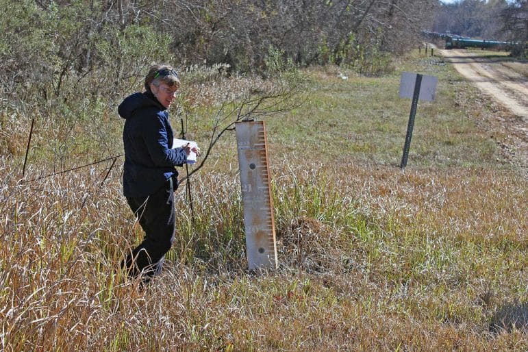 Joyce Dunkin of LimnoTech working on a field investigation