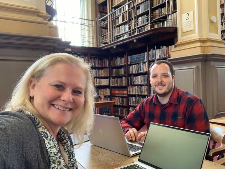 Laura Weintraub and Nate Jacobson working in a library in Edinburgh, Scotland.