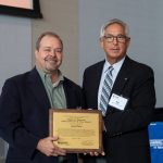 Chris Cieciek, Principal and Senior Environmental Scientist (left) of LimnoTech accepts the "Consultant of the Year Award" from Mike Trout, Executive Administrator of MDOT Office of Aeronautics and Director of MAC (right)