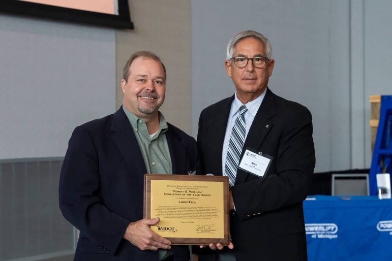 Chris Cieciek, Principal and Senior Environmental Scientist (left) of LimnoTech accepts the "Consultant of the Year Award" from Mike Trout, Executive Administrator of MDOT Office of Aeronautics and Director of MAC (right)